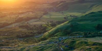 View of the sun setting over the Peak District