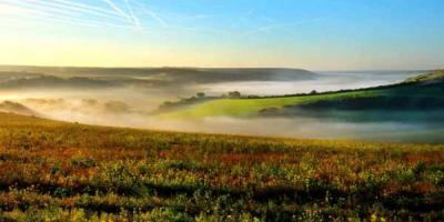 View of Cuckmere Valley at sunrise with mist