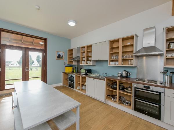 YHA National Forest kitchen with dining table and doors to the outdoor space