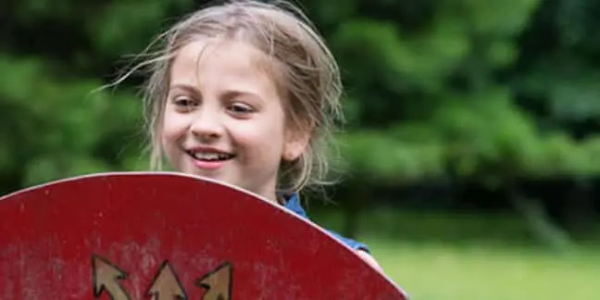 Young girl holding a Viking shield