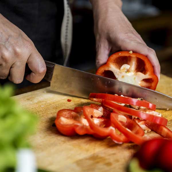 Chef chopping a bell pepper