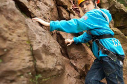 Child climbing a rock
