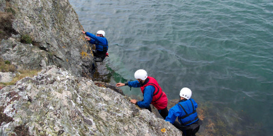 Group climbing alone the coast
